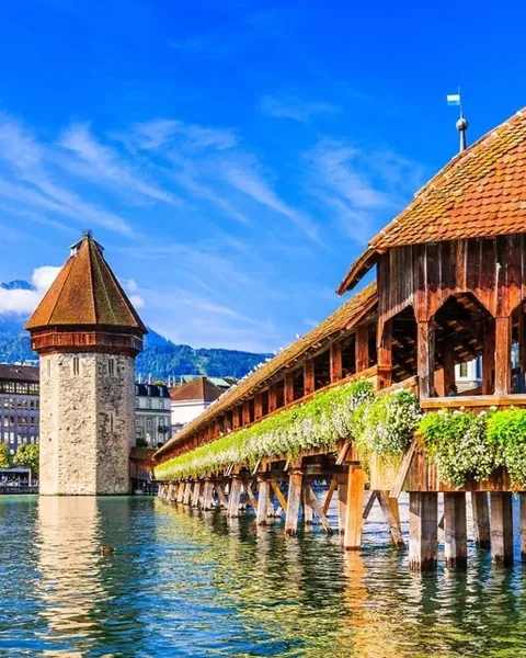 Lucerne's covered Chapel Bridge and stone Water Tower beside the river
