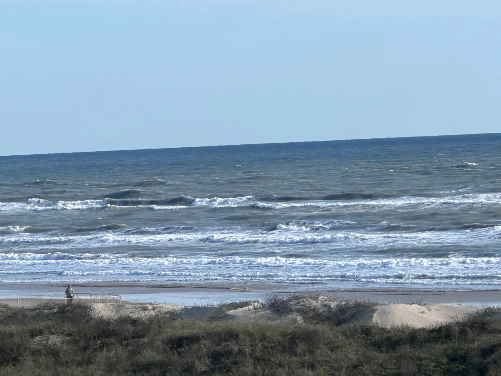 Waves rolling in over the dunes on the beach at South Padre Island, Texas