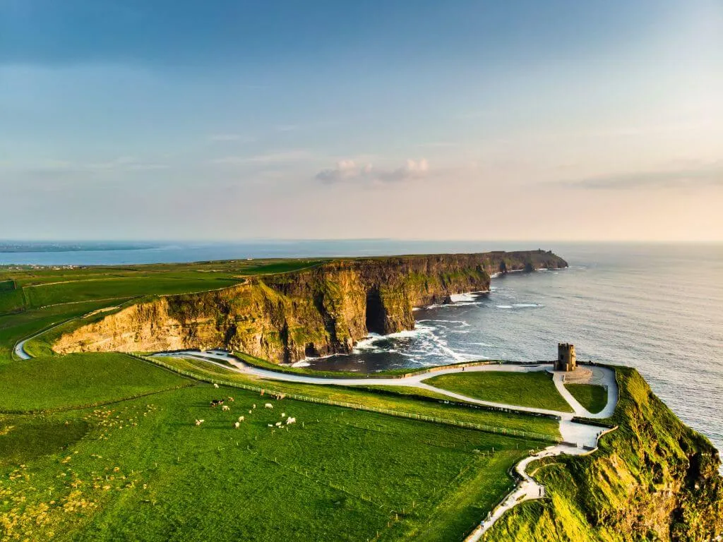 The Cliffs of Moher and O'Brien's Tower at golden hour, County Clare, Ireland