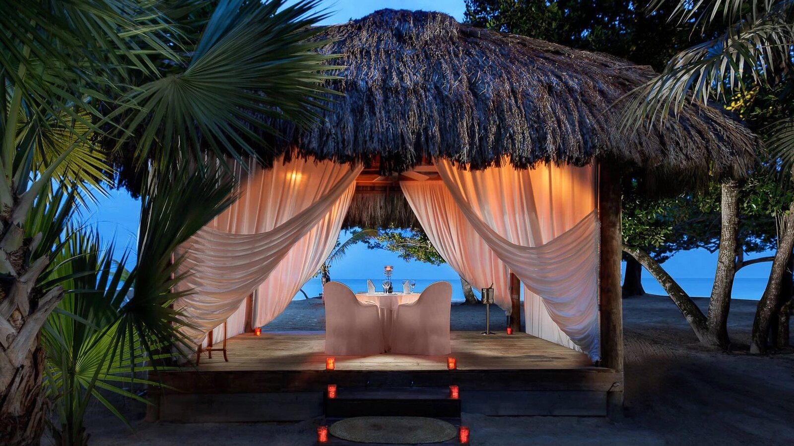Private candlelit beach dinner in a gazebo at Couples Negril, Jamaica