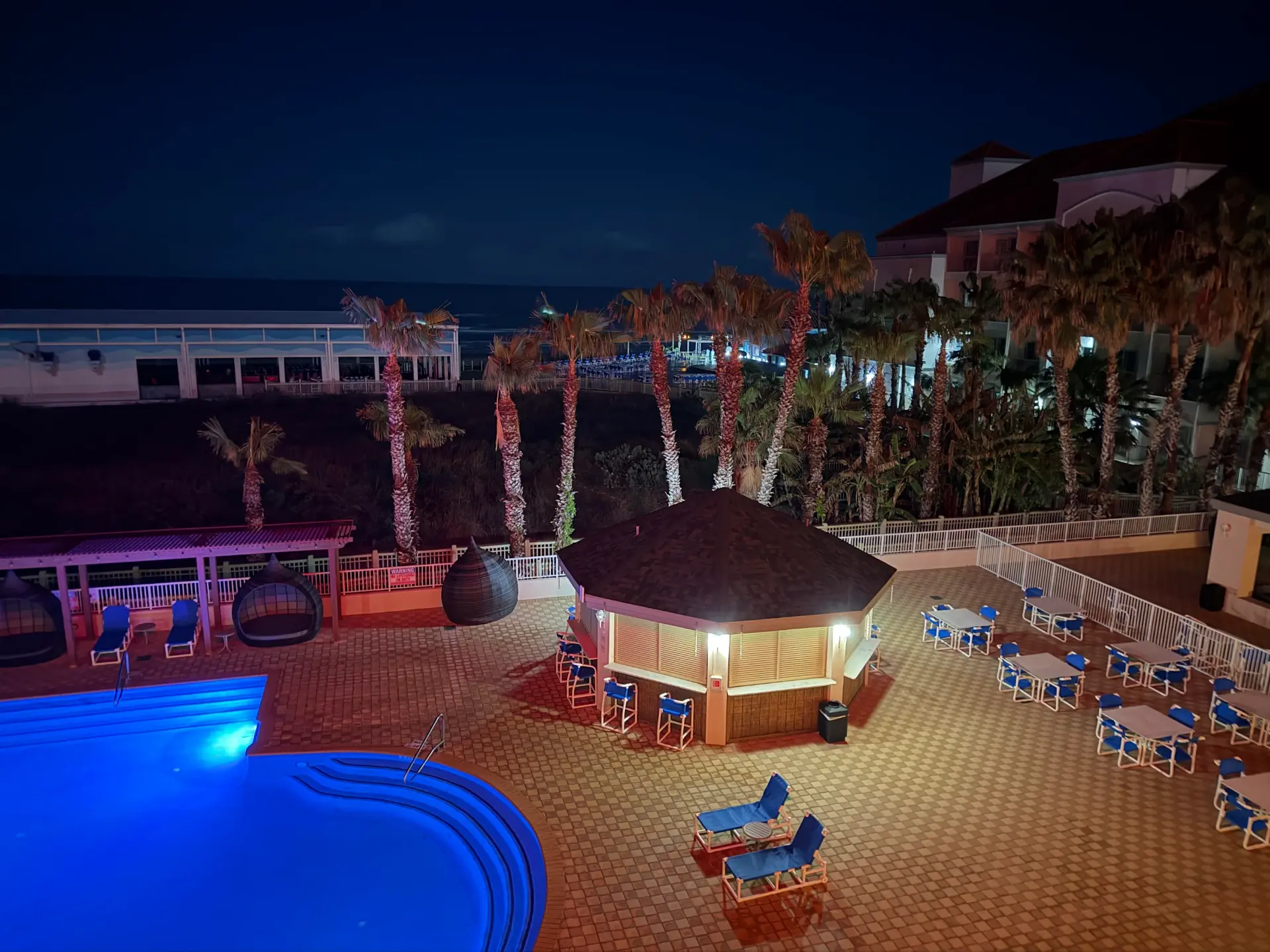 Pool and palms lit up at night at the South Padre Island hotel Gary stayed in on his winter getaway