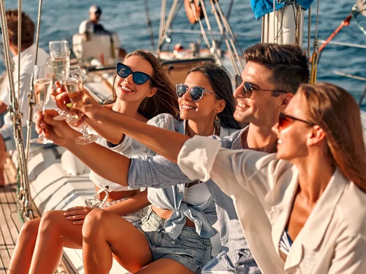 Friends raising champagne on a sailing yacht