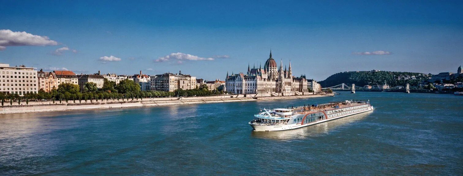 AmaWaterways river ship on the Danube passing the Hungarian Parliament in Budapest, luxury river cruise