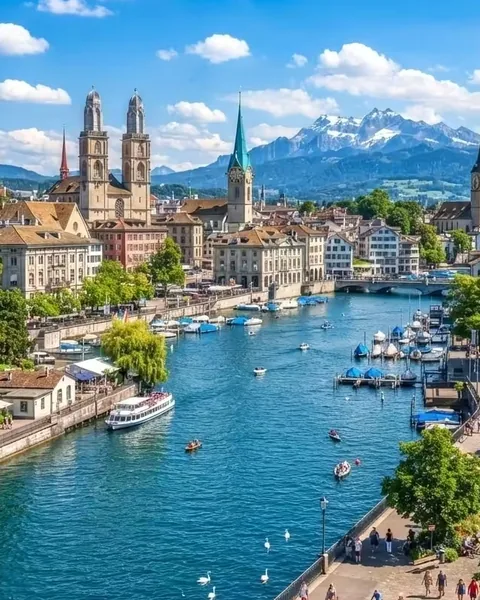 Zürich old town along the Limmat River with the Grossmünster towers and the Alps beyond